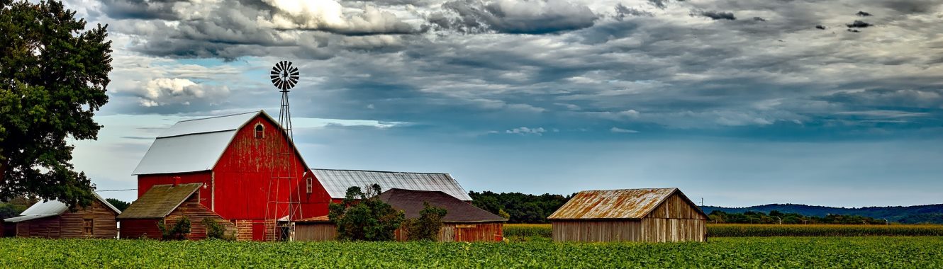 Large red barn with a windmill.